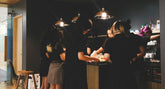 woman in black sleeveless dress standing beside woman in black dress
