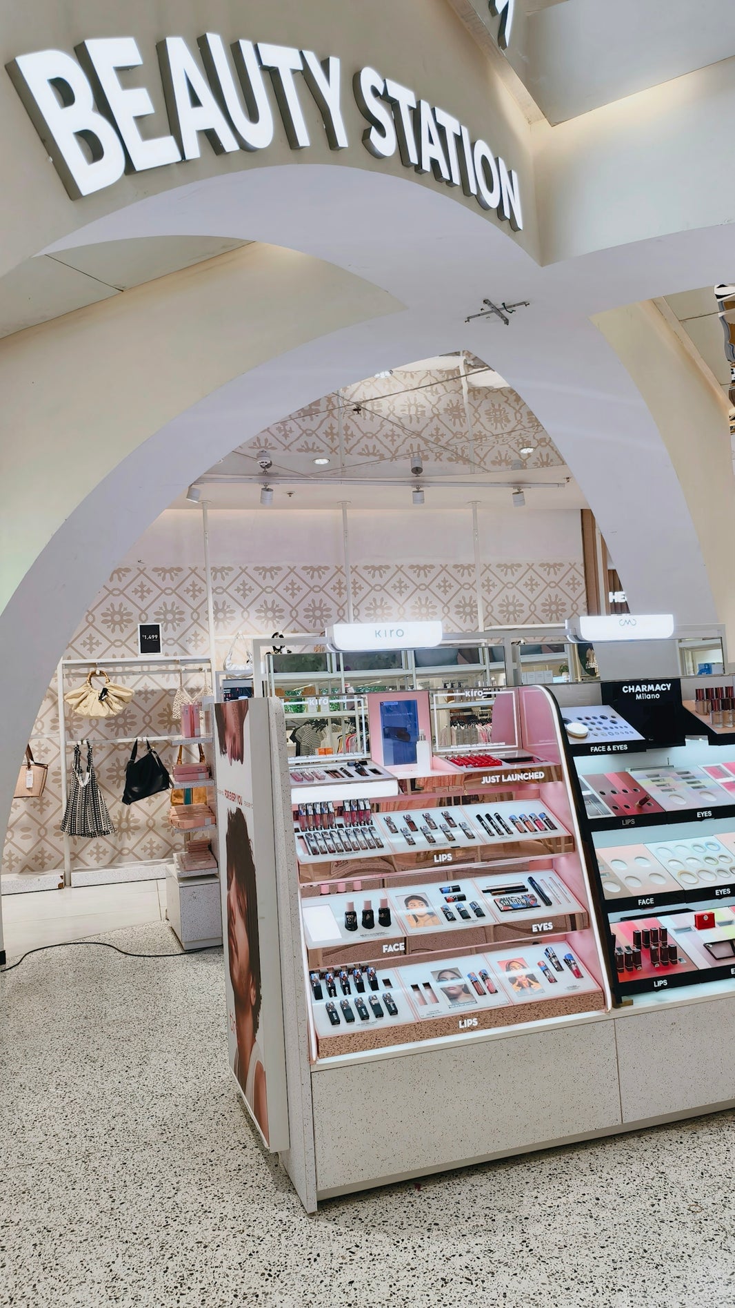 Cosmetics display shelves inside a Beauty Station store with various makeup products