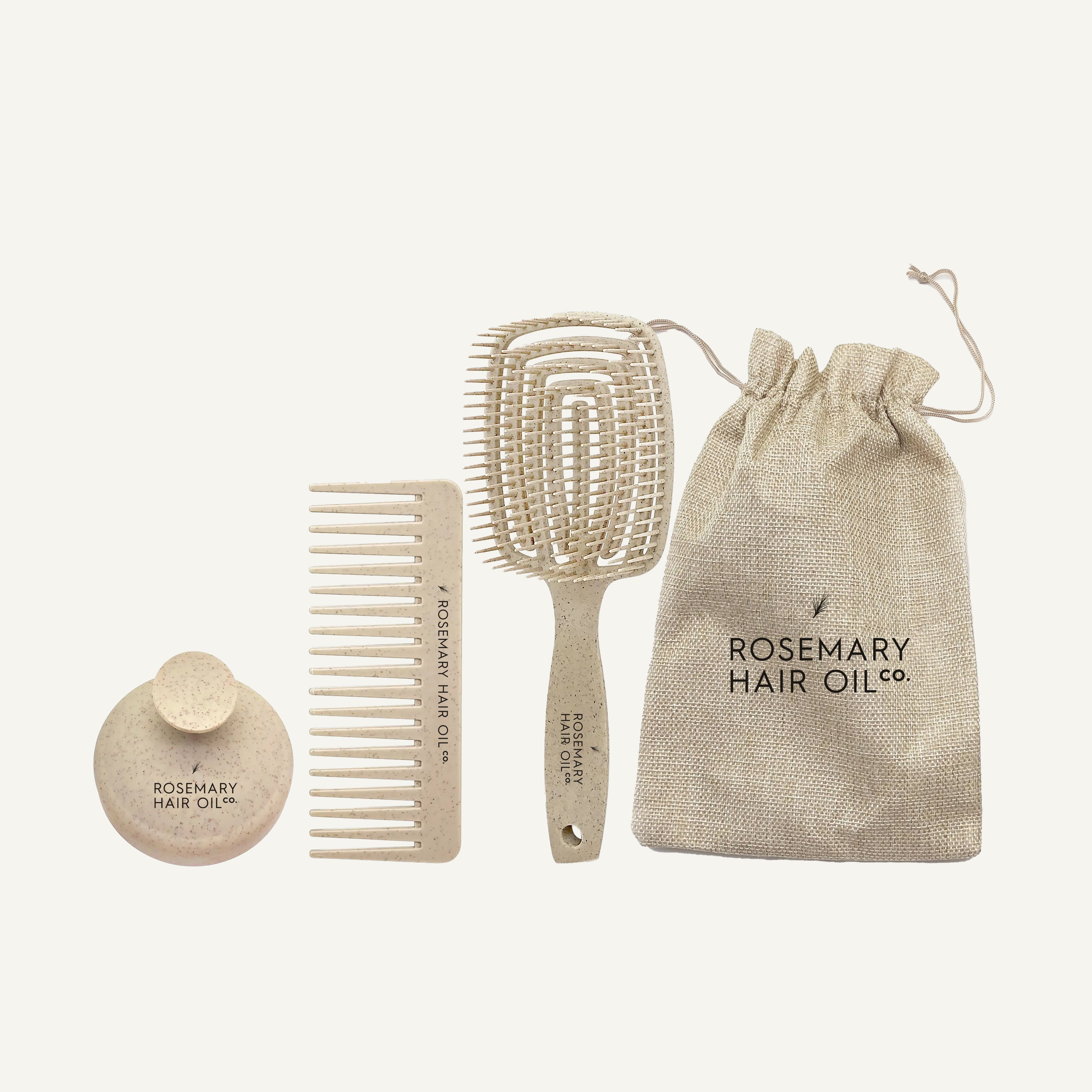 Set of hair care products including a comb, paddle brush, and oil container with 'Rosemary Hair Oil Co.' branding on a white background. Rosemary Hair Oil Co Hair Growth Accessories Set featuring scalp massage brush, wide-tooth comb and storage pouch